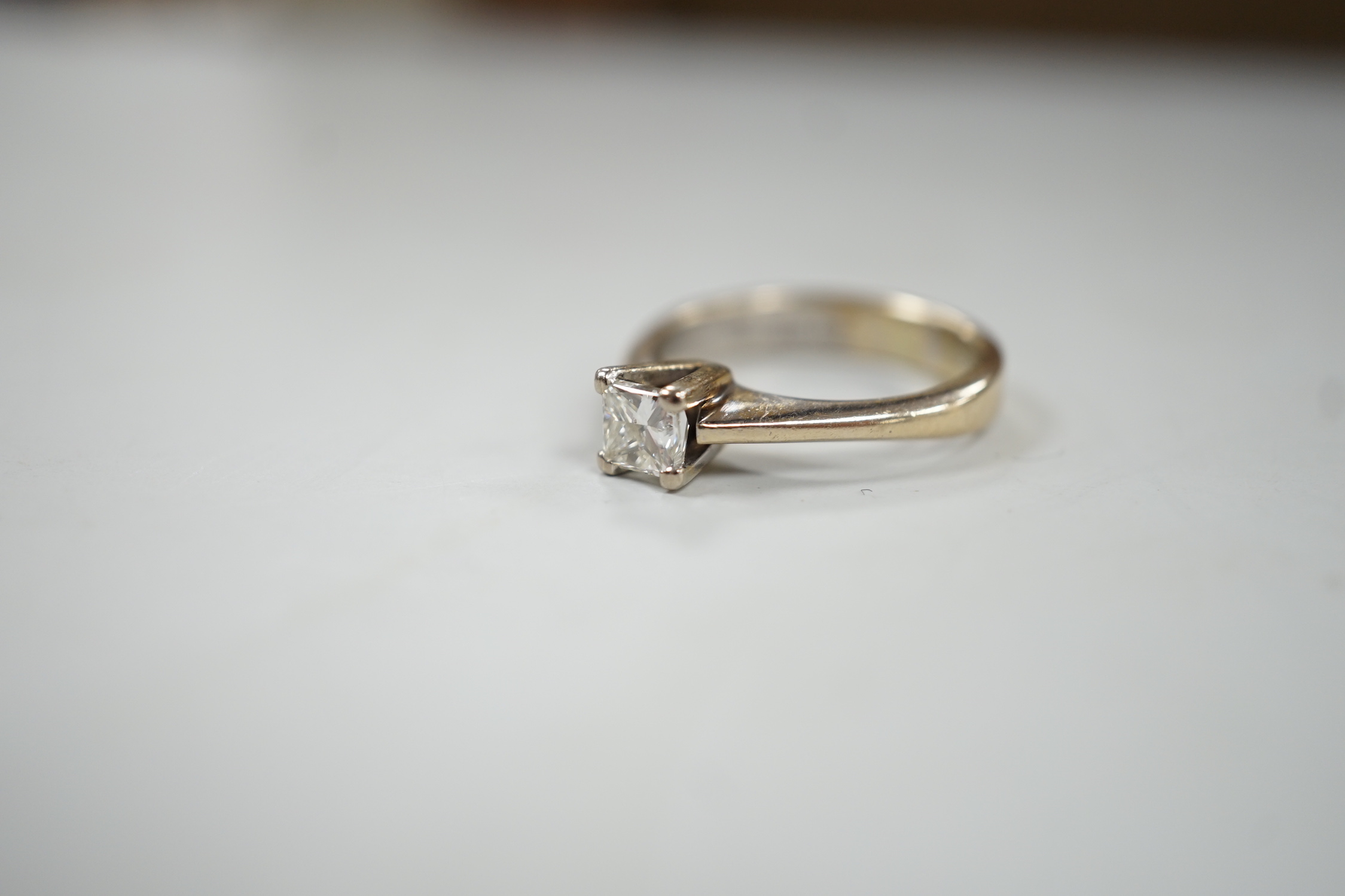 A modern Zen 18ct white gold and solitaire princess cut diamond set ring, the stone weighing 0.52ct, size K, gross weight 4.4 grams
